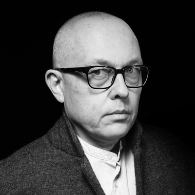 A black and white photo of a man wearing glasses