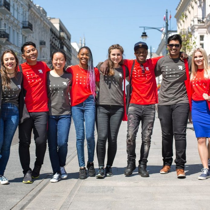 A group of young people of different races standing together on Piotrkowska Street in Lodz