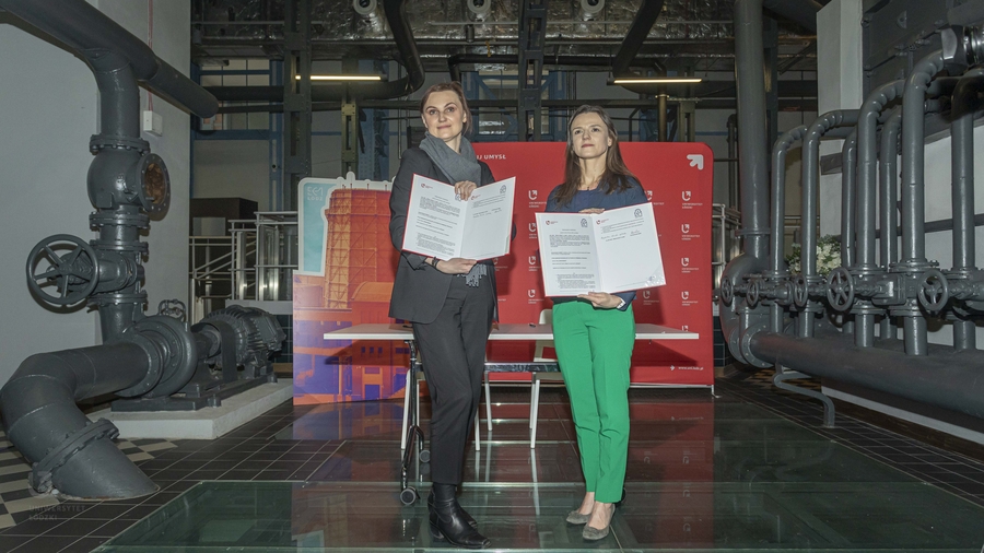 Prof. Kurczewska and Magdalena Kosiada-Sylburska with copies of the cooperation agreement in a post-industrial interior